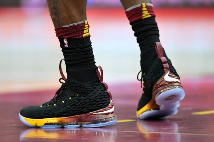 View of black and gold Nike LeBron shoes.
